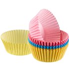Blue pink yellow paper muffin cups and cupcakes
